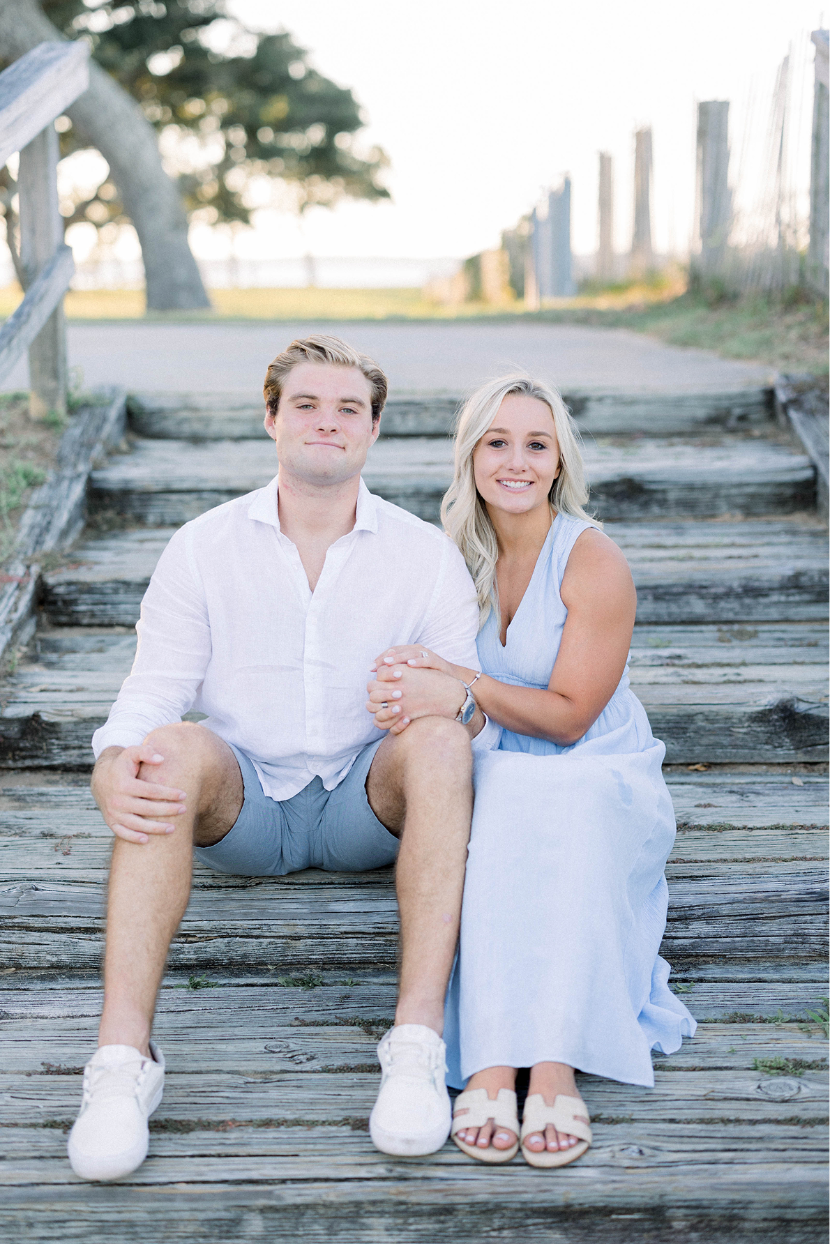 Sara and Jordan Darby , founders and owners of Coastal Capital Management sitting on pier in Wilmington NC.